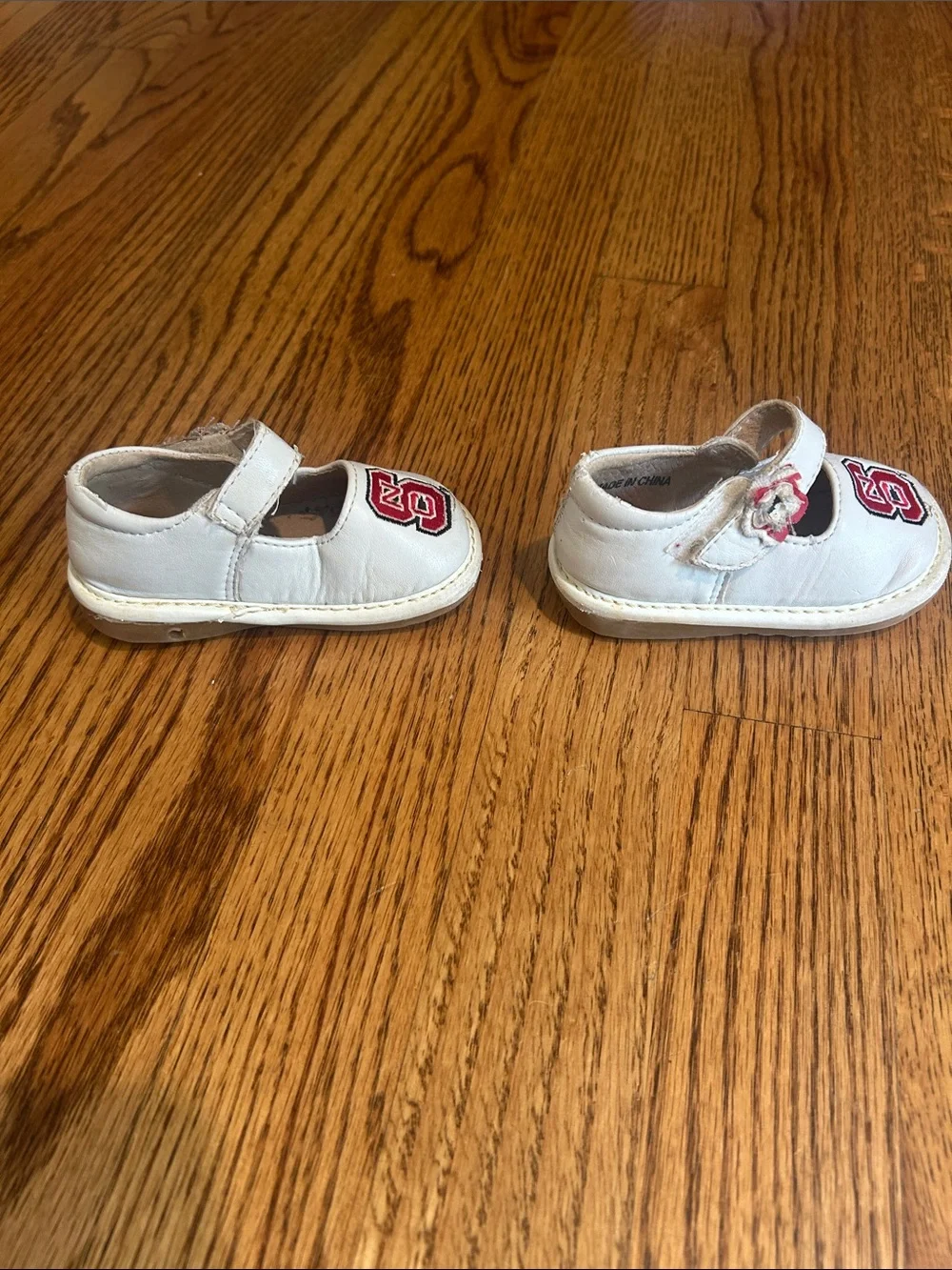 Team Squeaks Kids White Mary Jane Shoes with Red NC State Logo